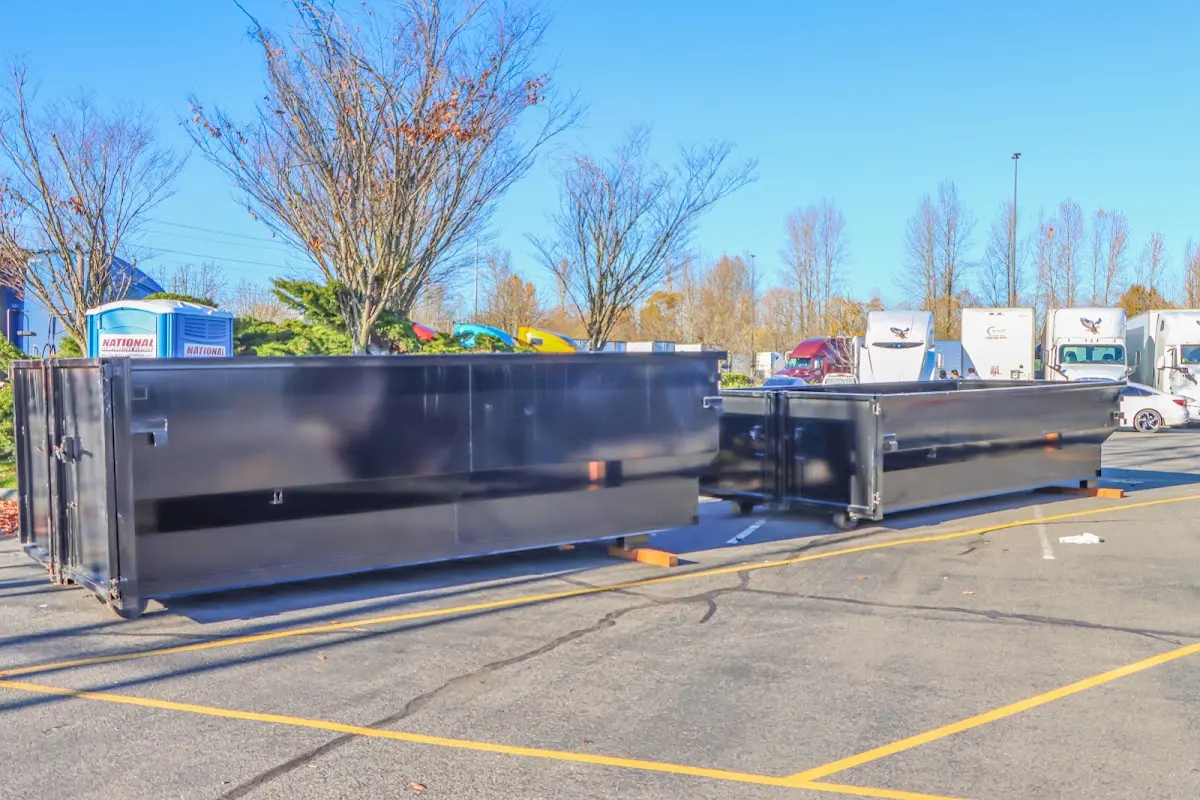 Professional dumpster rental service with roll-off container on residential driveway in Hunters Creek